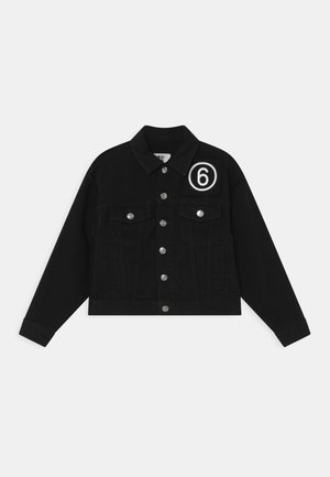 Schwarze Jeansjacke mit silbernen Knöpfen, zwei Brusttaschen und einem weißen, umkreisten Nummer-6-Patch auf der oberen linken Vorderseite.