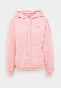 Vaaleanpunainen pehmeästä puuvillasta valmistettu hupullinen collegepaita. Varustettu säädettävällä kiristysnyörillä, etutaskulla ja rintakehällä hennosti brodeeratuilla logolla.