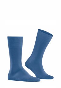 Blaue Socken aus glattem, dehnbarem Material. Mit einem gerippten Bündchen und einer nahtlosen Zehenpartie. Die Designs sind einfarbig und einheitlich.