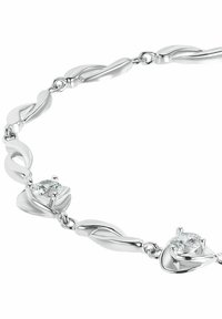 Silver bracelet featuring intertwined shapes and two clear gemstones set in a prong setting, with a smooth and polished finish.