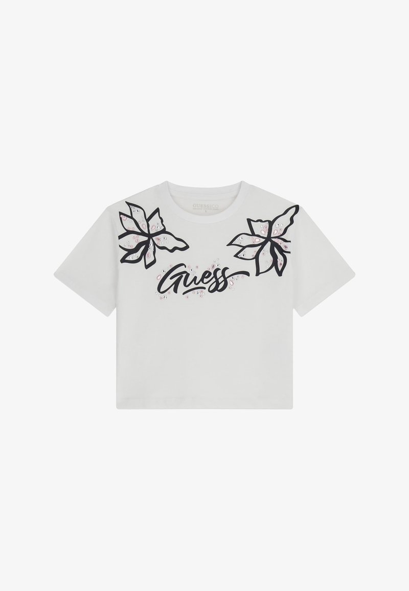 Witte T-shirt met korte mouwen met zwarte bloemmotieven op de schouders en de tekst "Guess" in een gestileerde lettertype in het midden. Van katoen.