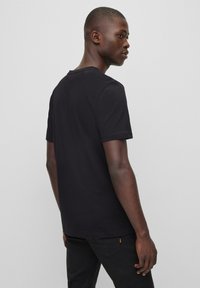 BOSS TALES - Basic T-shirt - black