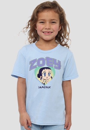 Smiling young girl with curly hair wearing light blue T-shirt featuring cartoon character and the word "ZOEY" in purple letters.