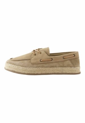 Beige suede boat shoe with side lace details and braided jute platform sole, viewed from the outer side on a white background.