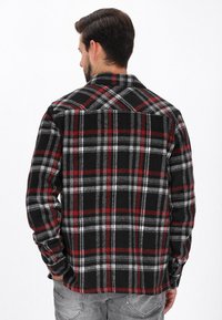 Svart, röd och grå rutmönstrad flanellskjorta med knapp-up-design, långa ärmar och klassisk krage, med ett mjukt, texturerat tyg.