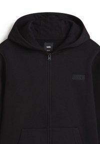 Svart zip-up hoodies i mjukt tyg, med en framfäste dragkedja, två sidofickor och broderad Vans-logga på bröstet.