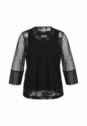 Blouse en dentelle noire avec manches 3/4 transparentes à pois et col en V, avec des détails en dentelle florale sur le corps et les poignets.