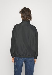 New Balance SPORT JACKET - Treniņjaka - black