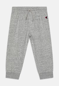 Pantalones de chándal grises hechos de un tejido suave, con una cintura elástica que incluye un cordón y puños acanalados en los tobillos. Detalle del logo bordado.