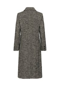 Long manteau en laine avec motif chevrons noir et blanc, coupe droite, manches longues et col, vu de dos.