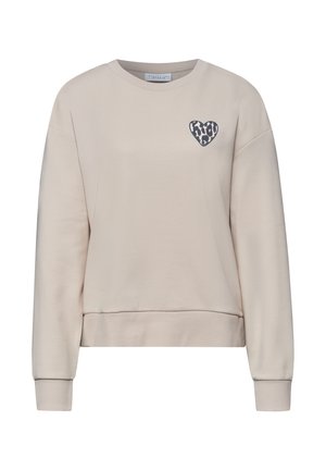 Beige pitkähihaisen collegepaita, jossa resorit hihansuissa ja helman reunassa, vasemman rinnan kohdalla pieni mustavalkoinen leopardikuosinen sydän.