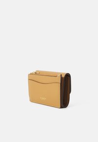 Folded yellow leather wallet with a smooth texture, features a zippered compartment, curved front design, and embossed logo detail.