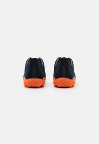 Navy blue athletic shoes with orange rubber soles, featuring a smooth upper, rounded shape, and padded collar for comfort.
