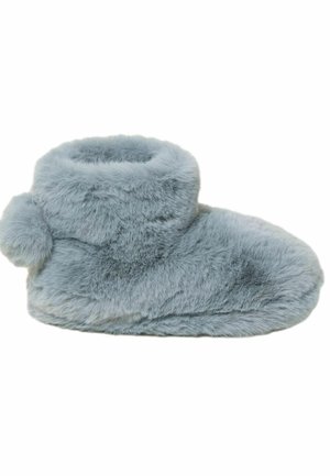 Faux fur slipper in light blue with a rounded shape, ankle height, and soft texture. Features a small pom-pom accent on the side.