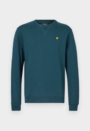 Sweatshirt bleu sarcelle à manches longues, avec poignets et ourlet côtelés. Présente un petit logo brodé jaune sur la poitrine et un col rond.