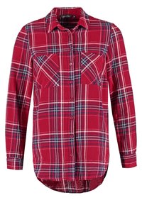Red and blue plaid flannel shirt with long sleeves, two chest pockets, button front closure, and curved hem. Soft fabric texture.