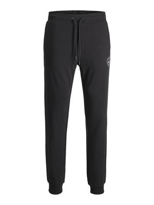 Schwarze Jogging-Hosen aus Baumwollmischung. Sie verfügen über einen elastischen Bund mit Kordelzug, gerippte Säume und ein kleines aufgedrucktes Logo am Oberschenkel.