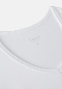 White cotton tank top with a rounded neckline and stitched trim. The label reads "FINN" with a size indicator, displayed in a subtle gray.