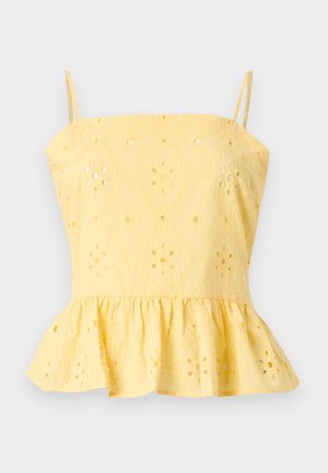 Top jaune sans manches à basque avec fines bretelles et motifs floraux ajourés brodés sur tout le tissu.