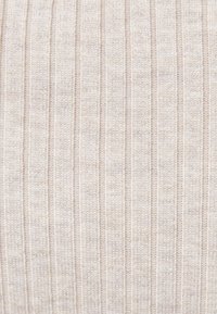 Jasnobeżowa prążkowana dzianina z pionowymi paskami, prezentująca miękką teksturę i równy wzór na całej powierzchni. Odpowiednia do różnorodnej odzieży.