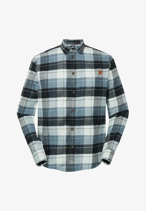 Chemise en flanelle à carreaux comprenant des couleurs bleu foncé, bleu clair, noir et blanc, avec une patte de boutonnage à l'avant et une poche poitrine.