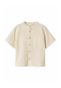 Camicia a maniche corte, di un leggero color beige, con colletto rotondo, taschino sul petto e cinque bottoni sul davanti. Tessuto con texture liscia.