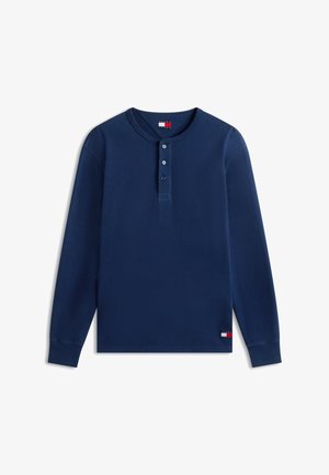 Μπλε ναυτικό μακρυμάνικο πουκάμισο Henley με τρία κουμπιά, ριμπ μανσέτες και μικρά λογότυπα Tommy Jeans στον λαιμό και το τελείωμα.