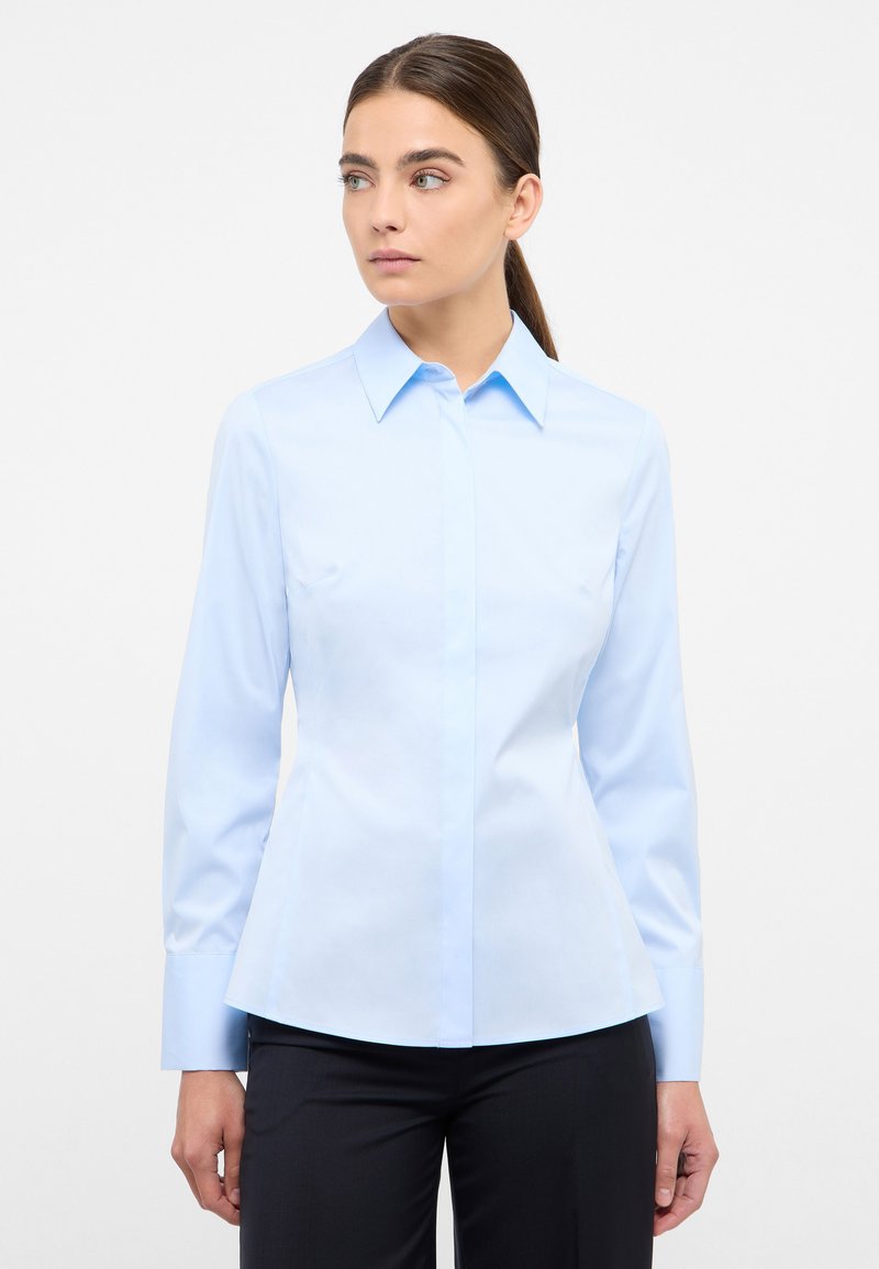 Light blue button-up shirt with a classic collar, long sleeves, and a fitted design. Made of smooth fabric; no visible patterns or accents.