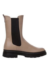 Botte cheville en cuir beige avec des panneaux latéraux élastiques noirs, à bout rond et semelle épaisse noire. Caractéristiques de couture décorative sur la tige.