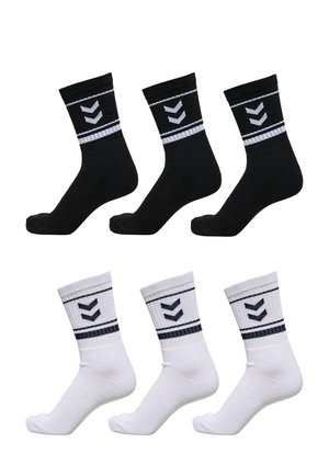 Black and white socks, textured cotton with ribbed cuffs, featuring a horizontal stripe and a chevron design in contrasting colors. Six pairs total.