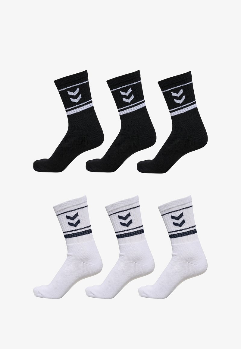 Black and white socks, textured cotton with ribbed cuffs, featuring a horizontal stripe and a chevron design in contrasting colors. Six pairs total.
