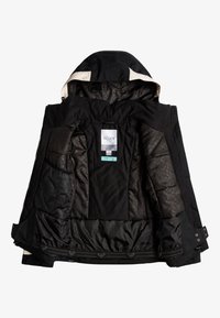 Veste noire avec capuche, présentant un extérieur lisse, une doublure matelassée et plusieurs poches intérieures. Étiquette "Roxy" visible à l'intérieur.