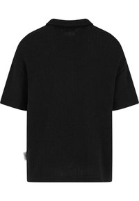Svart kortermet polo-skjorte med ribbestruktur, med liten krage og sideskilt, designet med en avslappet, løs passform.