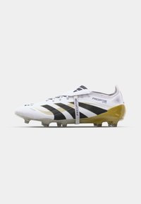 White soccer cleat with black and gold accents. Features a textured upper, a snug fit, and a prominent logo on the side.