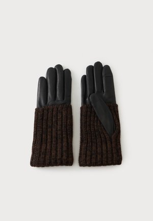 Paire de gants en cuir noir avec poignets en tricot marron foncé, posés à plat sur un fond clair.
