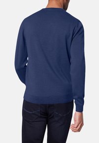 Marinblauer Pullover mit Rundhalsausschnitt, strukturiertem Strickstoff, langen Ärmeln sowie gerippten Bündchen und Saum. Die Rückansicht zeigt eine glatte Verarbeitung und Passform.