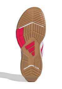 Rubberen buitenzool met een gestructureerd patroon, met rode en tan secties en witte accenten. Toont groeven voor grip en flexibiliteit.