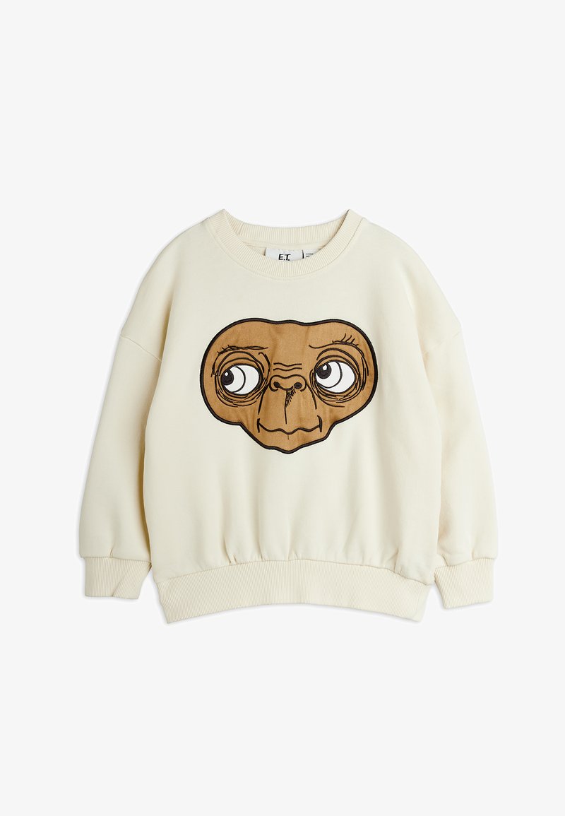 Krémová mikina s potiskem obličeje pohádkového E.T. v hnědé barvě. Má žebrované manžety a lem, kulatý výstřih a měkkou texturu.