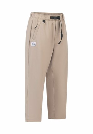 Beige, elastische broek met een zwarte aantrekkoord, zijzakken en een klein logo-embleem. Gladde textuur met een relaxte pasvorm en cropped lengte.
