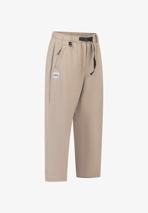 Beige, elastische Hose mit schwarzem Kordelzug, Seitentaschen und einem kleinen Logopatch. Glatte Textur, lockere Passform und cropped Länge.