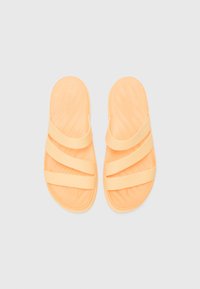 Orange slide sandals with three upper straps and a contoured footbed. Made of soft, flexible material, featuring a textured surface.