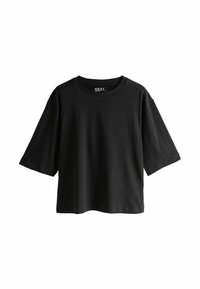 Musta ylisuuri lyhythihainen T-paita pyöreällä pääntiellä, hieman lasketuilla harteilla ja pienellä "NEXT"-etiketillä kaulan takana.