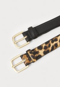 Two belts: one black leather with a gold buckle, and one leopard print pattern with a gold buckle, both with smooth texture and similar width.