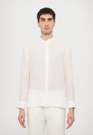 White linen long-sleeve shirt with a mandarin collar, featuring a button front, slightly sheer texture, and a relaxed fit.