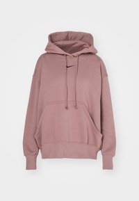 Felpa con cappuccio rosa dotata di tasca a marsupio, maniche lunghe, e logo Nike nero sul petto. Materiale morbido in misto cotone, vestibilità rilassata.