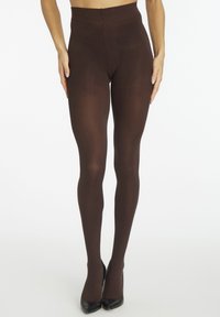 Brown opaque tights with a smooth texture, high-waisted design, and full coverage, paired with black high heels.