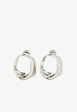 Silver hoop earrings with a sculptural, organic shape. They feature a textured surface and a polished finish for a modern look.