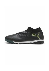 Zapatilla deportiva negra con parte superior texturizada, cuello elástico y acentos verdes. Presenta una suela intermedia blanca etiquetada como "PROFOAM LITE" y suela con tacos.