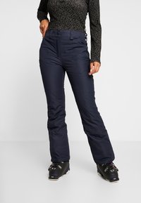 Marinevandsikre skibukser lavet af tekstureret stof, med lynlås i front, bæltestropper og lige ben for funktionalitet og komfort.