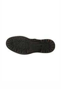 Suola nera di scarpa con una superficie texturizzata caratterizzata da modelli di battistrada circolari e lineari per una buona aderenza. Il materiale sembra essere gommato e resistente.